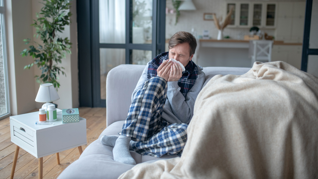 Sick man on couch - Mass Paid Sick LEave