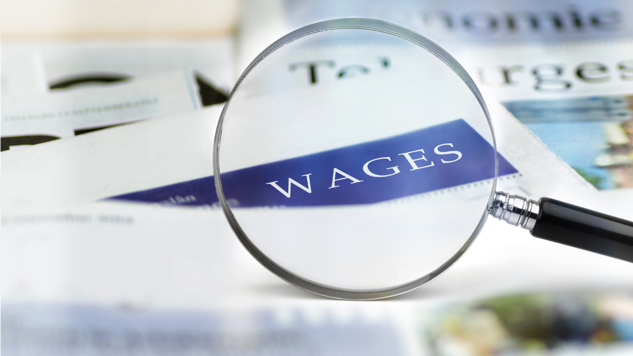 Magnifying glass on Wages document - Wage increases