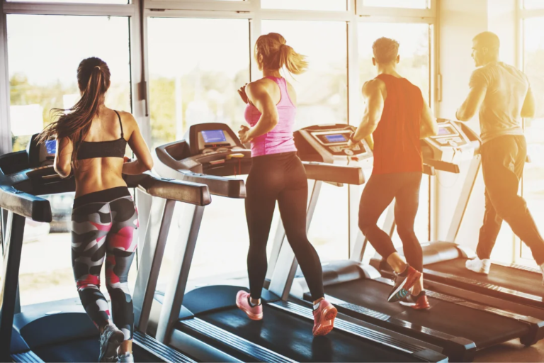 people running on treadmills at gym