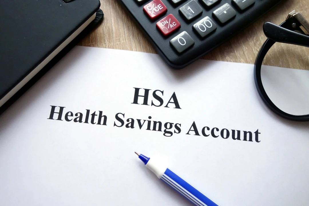 Photo of Health Savings Account paperwork and calculator referring to increased HSA limits