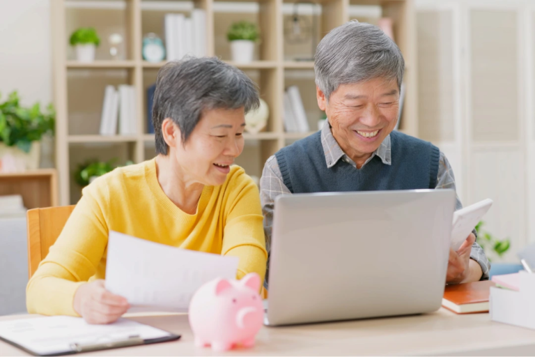 Asian Couple Planning Retirement at Computer