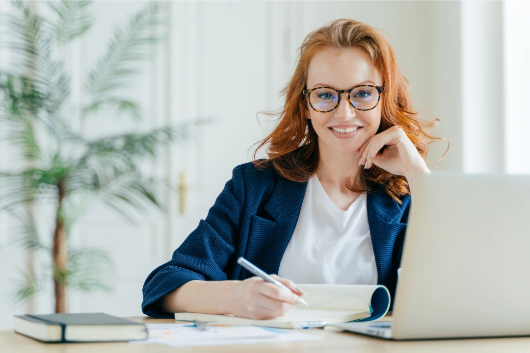 woman at computer with checklist and pen