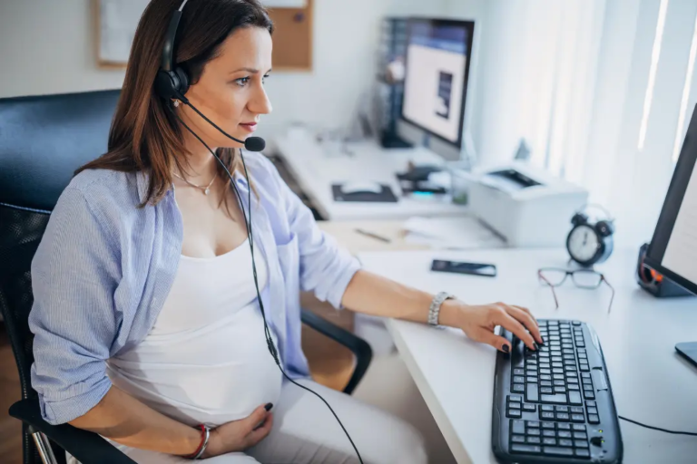 Pregnant Woman at work on desktop computer