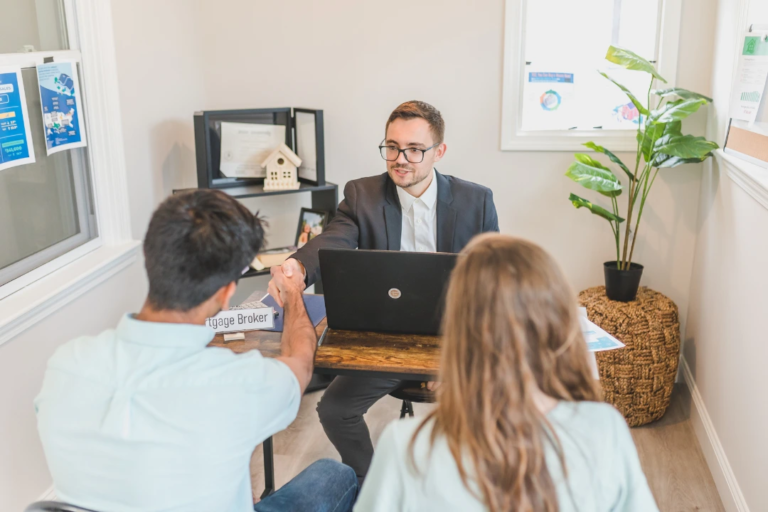 Couple meeting with a mortgage broker as part of a loan application supported by the automated employment and income verification process