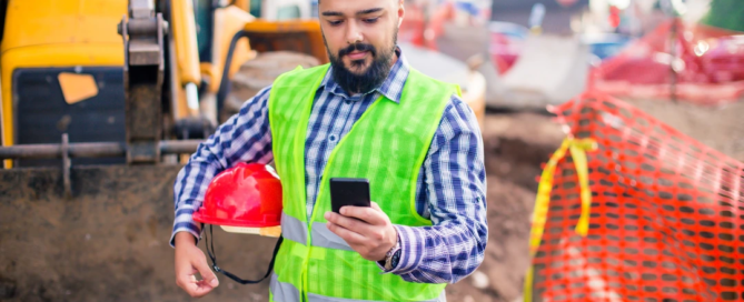 Construction worker using geofencing time tracking app on smartphone at a job site" Let me know if you’d like a version tailored for social media SEO or ADA compliance
