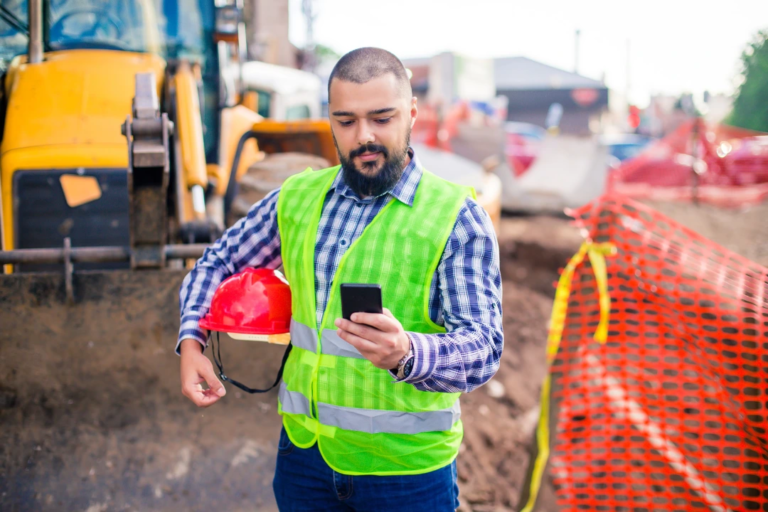 Construction worker using geofencing time tracking app on smartphone at a job site" Let me know if you’d like a version tailored for social media SEO or ADA compliance