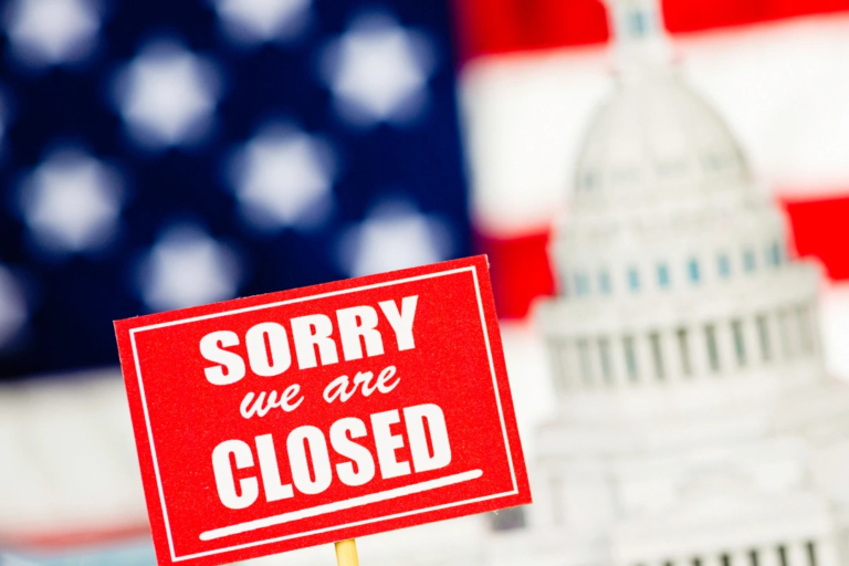 Government shutdown HR impact concept with closed sign, U.S. Capitol, and American flag in background