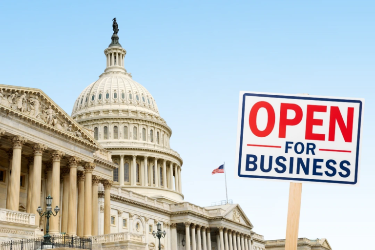 U.S. Capitol with an ‘Open for Business’ sign, representing the federal government reopening and its impact on HR and payroll operations.